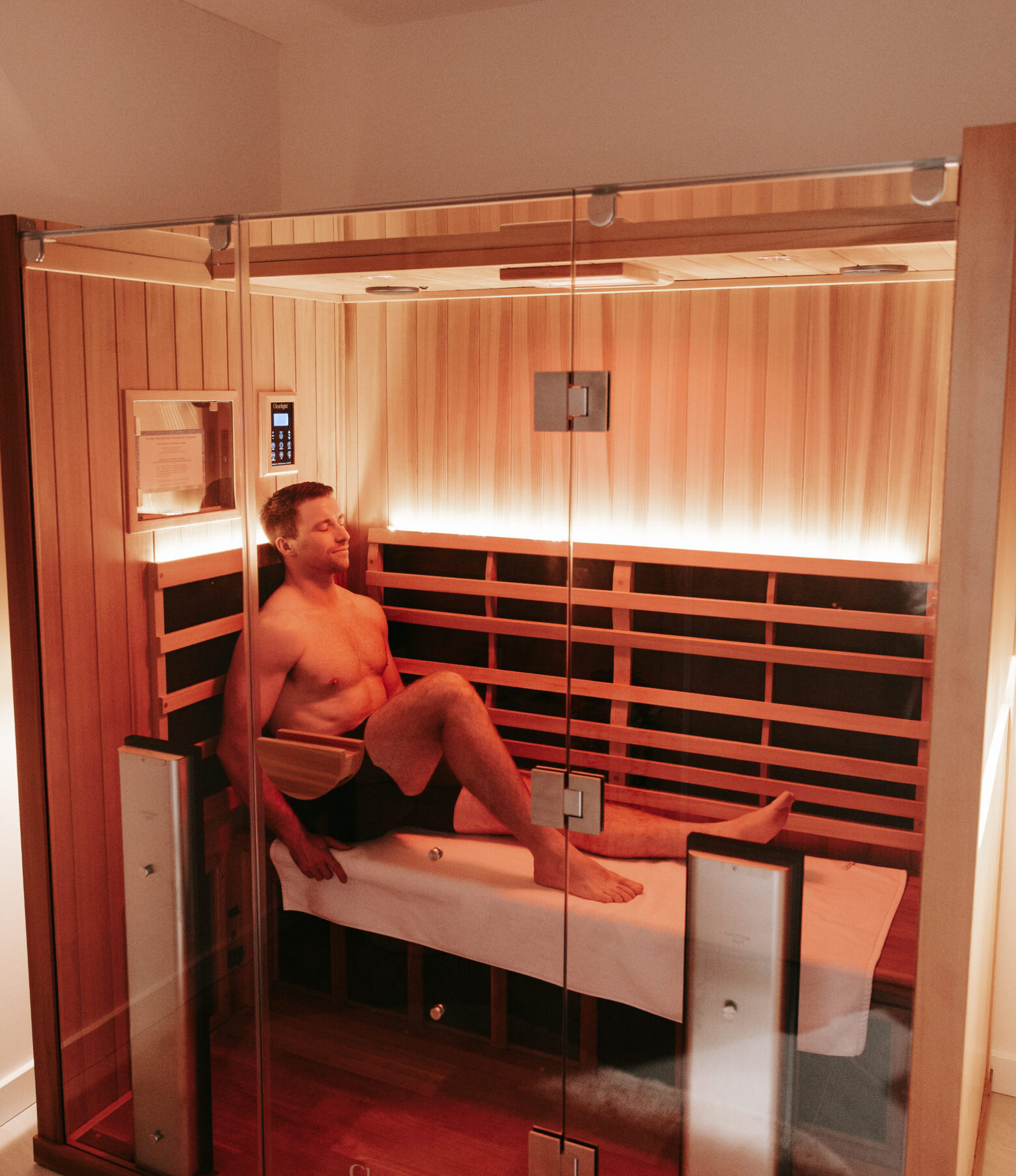 Client relaxing in the Full Spectrum Infrared Clearlight sauna at Body Sculpt Perth, enjoying the therapeutic benefits of infrared heat for relaxation, detoxification, and overall wellness.